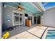 Outdoor living area featuring a bar, sliding glass doors, and a covered patio at 19750 Ellendale Dr, Land O Lakes, FL 34638
