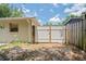 The backyard has a white privacy fence with wood posts and some grass at 2207 Valleybrook Ave, Valrico, FL 33594