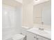 Bright bathroom with white fixtures, including a tub, toilet, and vanity with mirror at 2207 Valleybrook Ave, Valrico, FL 33594