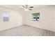 Well-lit bedroom with ceiling fan and windows offering natural light and neighborhood views at 2207 Valleybrook Ave, Valrico, FL 33594