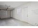Spacious garage with a metal door, small window, and access door to the home at 2207 Valleybrook Ave, Valrico, FL 33594