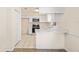 Bright kitchen featuring white cabinets, modern appliances, and a peninsula with an eat-in bar at 2207 Valleybrook Ave, Valrico, FL 33594