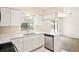 Updated kitchen showcasing white cabinets, stainless steel appliances, and quartz countertops at 2207 Valleybrook Ave, Valrico, FL 33594