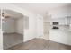 Bright living area leading to kitchen, featuring tile floors and modern white cabinets at 2207 Valleybrook Ave, Valrico, FL 33594