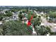 An aerial view showing a home surrounded by lush trees in a neighborhood setting near a street at 235 38Th S St, St Petersburg, FL 33711