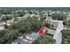 An aerial view showing a home surrounded by lush trees in a neighborhood setting near a street at 235 38Th S St, St Petersburg, FL 33711