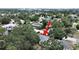 An aerial view showing a home surrounded by lush trees in a neighborhood setting with city views at 235 38Th S St, St Petersburg, FL 33711