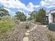 Backyard with stepping stones and raised garden beds creates a tranquil outdoor space for gardening and relaxation at 235 38Th S St, St Petersburg, FL 33711
