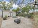 Inviting backyard with a cute shed, picnic table and fire pit, perfect for relaxing and entertaining outdoors at 235 38Th S St, St Petersburg, FL 33711