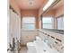 Cozy bathroom featuring tiled walls, a framed mirror, and a shower/tub combination at 235 38Th S St, St Petersburg, FL 33711