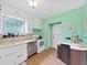 Kitchen with stainless appliances, bright green walls and white cabinetry at 235 38Th S St, St Petersburg, FL 33711