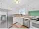 Well-lit kitchen featuring stainless appliances, a window over the sink, and ample counter space at 235 38Th S St, St Petersburg, FL 33711