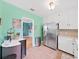 Bright kitchen with stainless steel refrigerator, white cabinets, and tile backsplash at 235 38Th S St, St Petersburg, FL 33711
