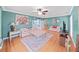 A spacious living room with beautiful hardwood floors, ample seating, and a ceiling fan at 235 38Th S St, St Petersburg, FL 33711