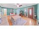 Well-lit living room with hardwood floors, a ceiling fan, comfortable seating, and charming decor at 235 38Th S St, St Petersburg, FL 33711