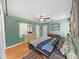 Comfortable bedroom featuring hardwood floors, ceiling fan, and ample closet space at 235 38Th S St, St Petersburg, FL 33711