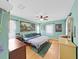 Charming bedroom featuring hardwood floors, ceiling fan, and ample closet space at 235 38Th S St, St Petersburg, FL 33711