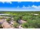 Aerial view of the townhome nestled among lush greenery, showcasing the community and nearby lake at 2418 Lake Woodberry Cir, Brandon, FL 33510