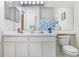 Bright bathroom featuring double sinks, white cabinets, and tile flooring at 2418 Lake Woodberry Cir, Brandon, FL 33510