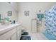 Bathroom with double sinks, a large mirror, and a shower with a blue patterned curtain at 2418 Lake Woodberry Cir, Brandon, FL 33510