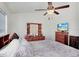 Bedroom with a ceiling fan, wooden dresser with mirror and a TV at 2418 Lake Woodberry Cir, Brandon, FL 33510