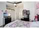 Spacious bedroom with a ceiling fan, TV, and decorative floral accents at 2418 Lake Woodberry Cir, Brandon, FL 33510