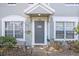 Up close view of the townhome entrance with a stylish gray door, and decorative accents at 2418 Lake Woodberry Cir, Brandon, FL 33510