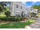 Exterior view of townhouse with well-maintained landscaping and a walkway at 2418 Lake Woodberry Cir, Brandon, FL 33510