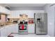 Bright kitchen with stainless steel appliances, white cabinets and granite countertops at 2418 Lake Woodberry Cir, Brandon, FL 33510