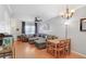 Open-concept living space boasts hardwood floors, a gray sectional sofa and dining area at 2418 Lake Woodberry Cir, Brandon, FL 33510