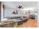 Spacious living room with hardwood floors, ceiling fan, and comfortable gray sectional sofa at 2418 Lake Woodberry Cir, Brandon, FL 33510