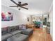 Comfortable living area featuring hardwood floors, a gray sectional sofa, and an open layout at 2418 Lake Woodberry Cir, Brandon, FL 33510