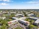 Wide aerial view showcasing community buildings, lush landscaping, and surrounding neighborhood at 2452 Brazilia Dr # 32, Clearwater, FL 33763