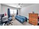 Bedroom featuring a bed, desk, and wooden dresser, well-lit by a window at 2452 Brazilia Dr # 32, Clearwater, FL 33763