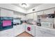 Kitchen featuring white cabinets and essential appliances like a stove, microwave, and sink at 2452 Brazilia Dr # 32, Clearwater, FL 33763