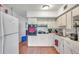 Kitchen featuring white cabinets and essential appliances including an oven, sink, and refrigerator at 2452 Brazilia Dr # 32, Clearwater, FL 33763