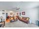 A cozy living room adjacent to dining space with comfortable furniture, including leather sofas at 2452 Brazilia Dr # 32, Clearwater, FL 33763