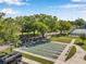Community shuffleboard court with manicured lawns, seating, and surrounding trees at 2452 Brazilia Dr # 32, Clearwater, FL 33763