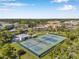 Overhead view of tennis courts with a clubhouse, pool and landscaping in the background at 2452 Brazilia Dr # 32, Clearwater, FL 33763