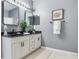 Updated bathroom features dual sinks with black countertops and modern fixtures at 30340 Elderwood Dr, Wesley Chapel, FL 33543