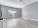 Spacious bedroom with wood floors, a large window and ceiling fan at 30340 Elderwood Dr, Wesley Chapel, FL 33543