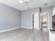 Empty bedroom with hardwood flooring with view into hall at 30340 Elderwood Dr, Wesley Chapel, FL 33543