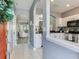 Open-concept entryway with views into the living room and kitchen, featuring neutral colors and archways at 30340 Elderwood Dr, Wesley Chapel, FL 33543