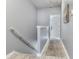 Hallway leading to upstairs bedrooms with updated walls, trim, and flooring at 30340 Elderwood Dr, Wesley Chapel, FL 33543