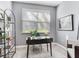 Bright home office featuring a modern desk, large window, and neutral colors at 30340 Elderwood Dr, Wesley Chapel, FL 33543