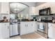 Bright kitchen with stainless steel appliances, white cabinets, and granite countertops, adjacent to dining area at 30340 Elderwood Dr, Wesley Chapel, FL 33543