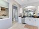 Spacious kitchen with granite countertops offering access to a convenient laundry room and half bath at 30340 Elderwood Dr, Wesley Chapel, FL 33543