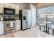 Well-lit kitchen featuring stainless steel appliances, black countertops, and a cozy breakfast nook at 30340 Elderwood Dr, Wesley Chapel, FL 33543