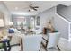 Comfortable living room with wood-look floors, ceiling fan, open to dining area, and neutral décor at 30340 Elderwood Dr, Wesley Chapel, FL 33543