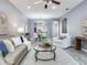 Cozy living room featuring a ceiling fan, elegant decor, and an open view to the dining area at 30340 Elderwood Dr, Wesley Chapel, FL 33543